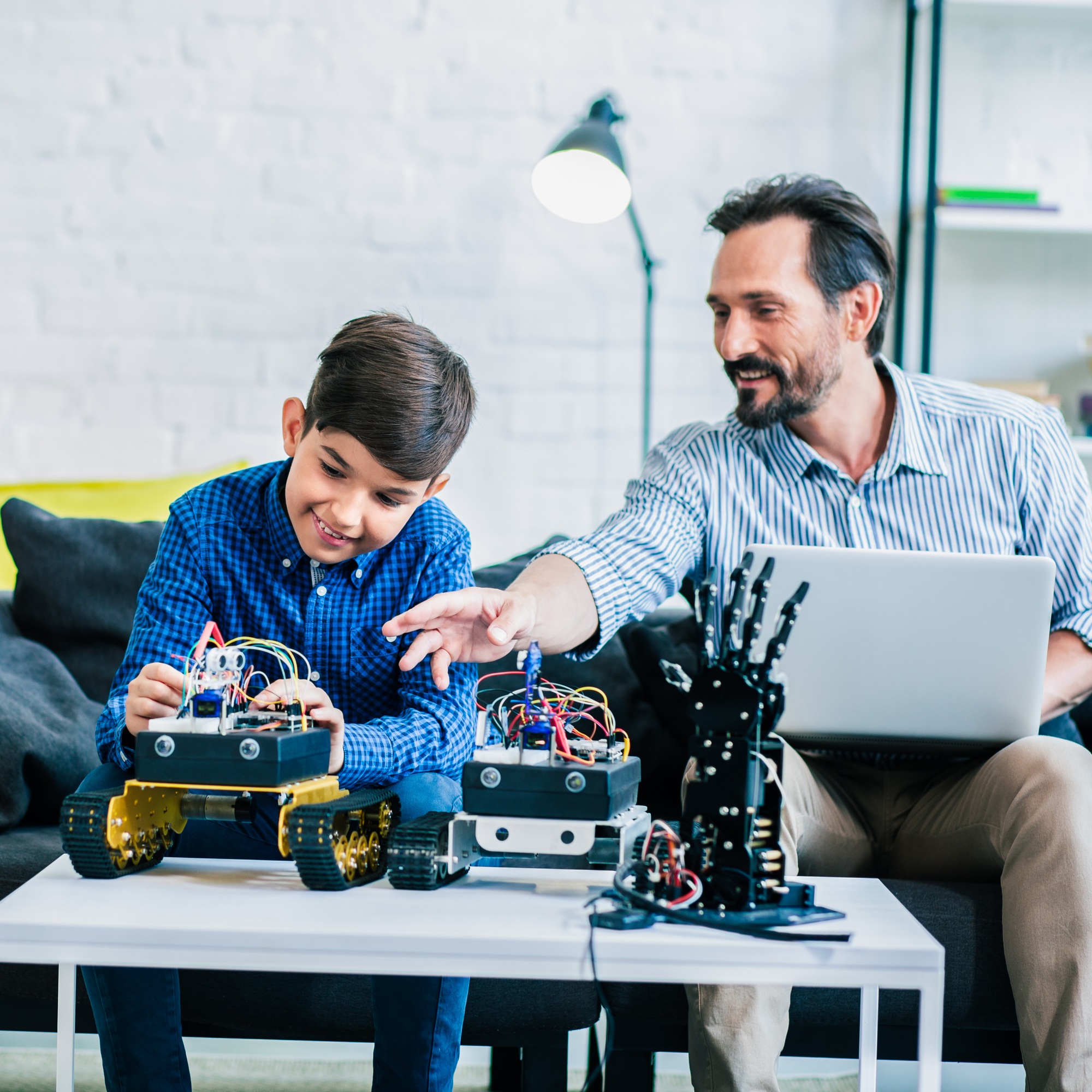 Father and son working on a robotic project.
