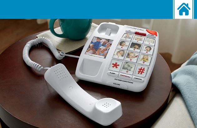 Picture-button white corded phone on an end table with a coffee cup